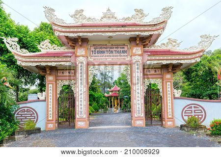 Long An, Vietnam - October 15th, 2017: Architectural beauty of ancient temple gate in  countryside. Temple was built in 1808, recognized as a national cultural monument in 1997 in Long An, Vietnam