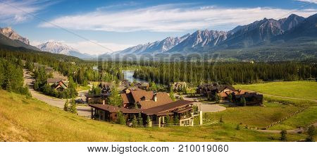 CANMORE, CANADA - JUNE 26, 2017 : Canmore in the Rocky Mountains with mountain peaks in background. Canmore is located in the Bow Valley near Banff National Park and is a popular tourist destination.