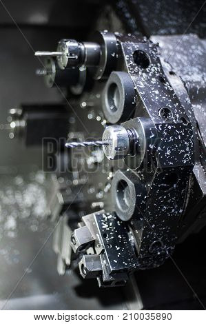 The CNC lathe machine or Turning machine drilling the metal rod with the drill tool and center drill tool .The hi-technology machining concept.