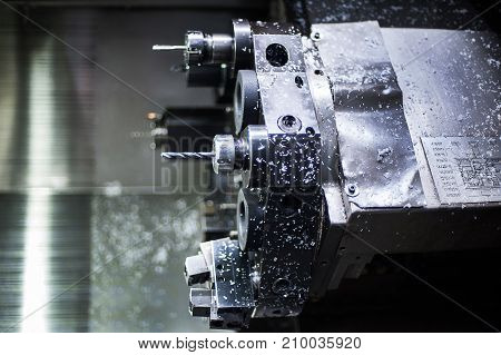 The CNC lathe machine or Turning machine drilling the metal rod with the drill tool and center drill tool .The hi-technology machining concept.
