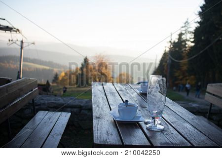 Close up on beer and coffee glass on the table in mountain