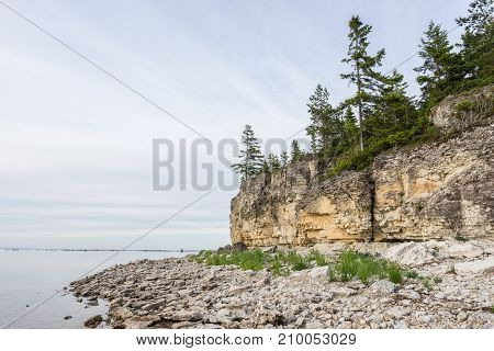 Sunset on the beach. Limestone cliff in the sea under blue sky and white clouds. Kesselaid a small island in Estonia. Nordic countries Europe