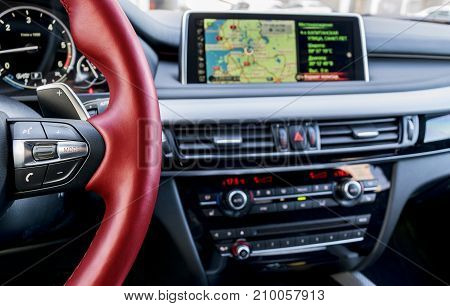 Modern car interior red steering wheel with media phone control buttonsnavigation screen multimedia system background car interior details