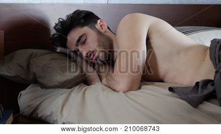 Young Handsome Shirtless Man Sleeping, Lying in Bed in the Morning