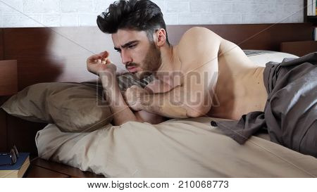 Young Handsome Shirtless Sleepy Man, Lying in Bed as He's Waking Up