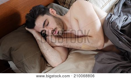 Young Handsome Shirtless Man Sleeping, Lying in Bed in the Morning