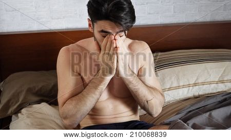 Young Handsome Shirtless Sleepy Man, Lying in Bed Yawning as He's Waking Up