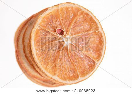 Stack of dried oranges on white background