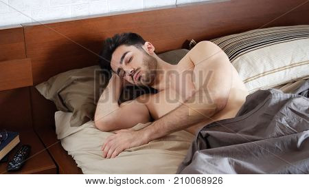 Young Handsome Shirtless Man Sleeping, Lying in Bed in the Morning