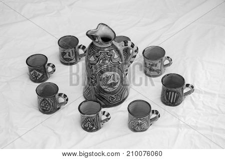 a group of cups and a pitcher made of ceramic