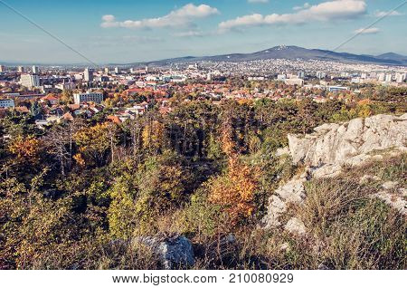 Nitra city under Zobor hill in autumn time. Slovak republic. Urban scene. Seasonal scene. Travel destination. Retro photo filter.
