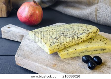 Homemade Haloumi Cheese On Wooden Board With Olives