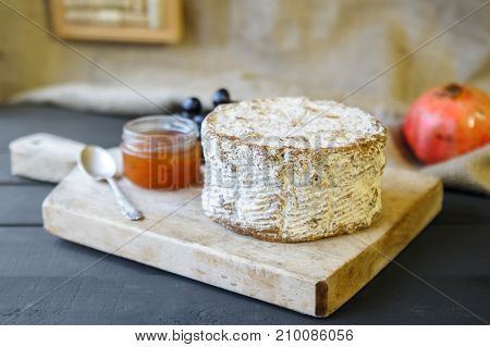 Homemade Shropshire Blue Cheese On Wooden Board With Grapes And Jam