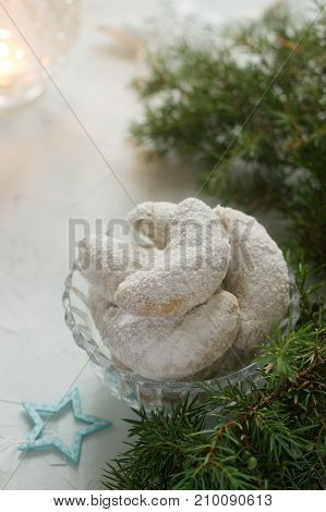 Vanilkipferl - vanilla crescents traditional Christmas cookies in Germany Austria Czech Republic. Homemade cookies in Christmas or New Year's decor. Selective focus.