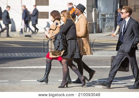 London, UK - March 15, 2017: Walking people in the City of London, Bank street.