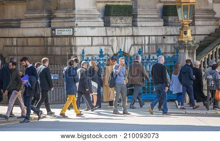London, UK - March 15, 2017: Walking people in the City of London, Bank street.