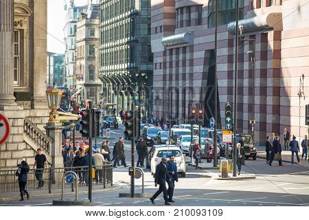 London, UK - March 15, 2017: Walking people in the City of London, Bank street.