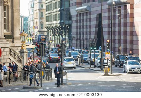 London, UK - March 15, 2017: Walking people in the City of London, Bank street.