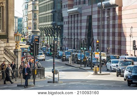 London, UK - March 15, 2017: Walking people in the City of London, Bank street.