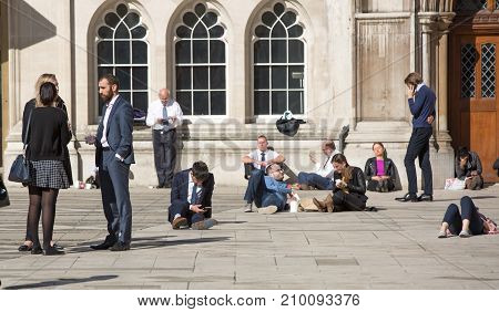 People having a rest during the lunch time in the City of London.