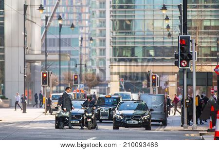 London, UK - March 15, 2017: Busy Bank street in Canary Wharf with lots of traffic and walking people