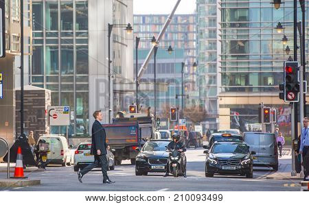 London, UK - March 15, 2017: Busy Bank street in Canary Wharf with lots of traffic and walking people