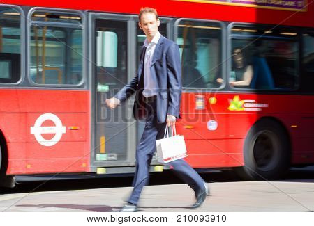 LONDON, UK - June 9, 2017: Blurred image of walking man with shopping bag at Oxford street, the main destination for shopping at Westend.