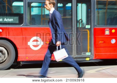 LONDON, UK - June 9, 2017: Blurred image of walking man with shopping bag at Oxford street, the main destination for shopping at Westend.