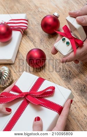 Romantic couple gives holiday Christmas gifts with red bows and Christmas deocorations