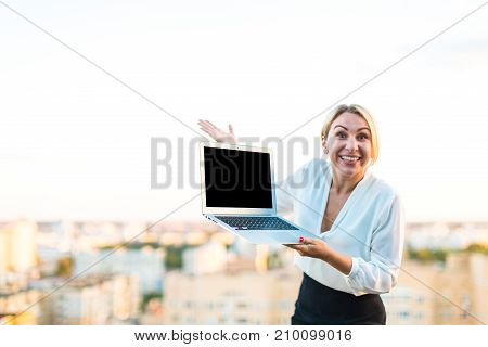 Beautiful Smart Business Lady Stand On The Roof With Laptop In Hands, Show Empty Laptop