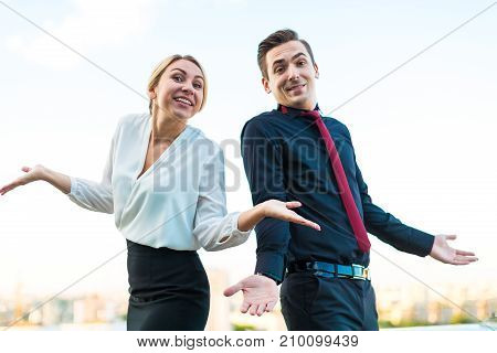 Couple Of Businessmen, Attractive Brunette Man And Pretty Blonde Woman Stand On The Roof Back To Bac