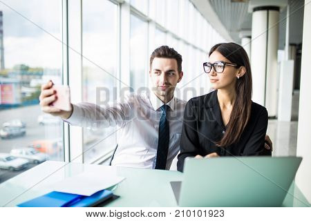 Two Colleagues Friends Taking The Picture To Them Self Sitting In The Office, Man And Woman Taking S