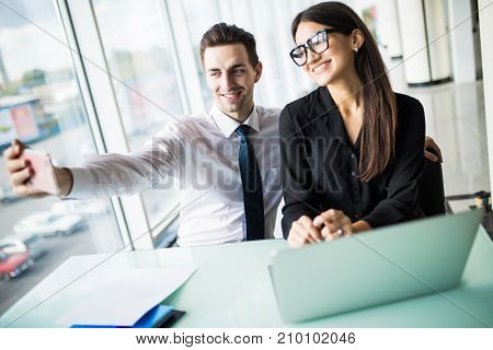 Two Colleagues Friends Taking The Picture To Them Self Sitting In The Office, Man And Woman Taking S