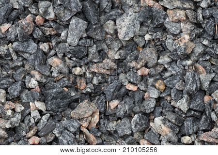 Seamless texture of close up granite breakstone gravel. Crushed stone background for design usage.