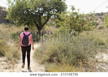 Woman walking in the mountains of Elche Alicante province in Spain.