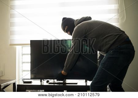 Man Stealing Tv In A House