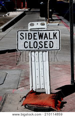 Sidewalk closed sign board closing a sidewalk