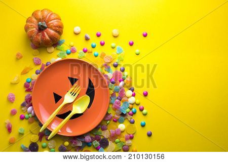 halloween dish with spoone and  decoration with colorful candy