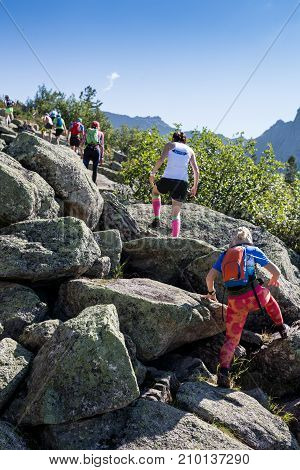 ERGAKI, RUSSIA - AUGUST 05 2017: Several athletes run through the mountains, participants trailing the SKAYRANFEST competition on August 5, 2017 in the Ergaki National Park, Russia