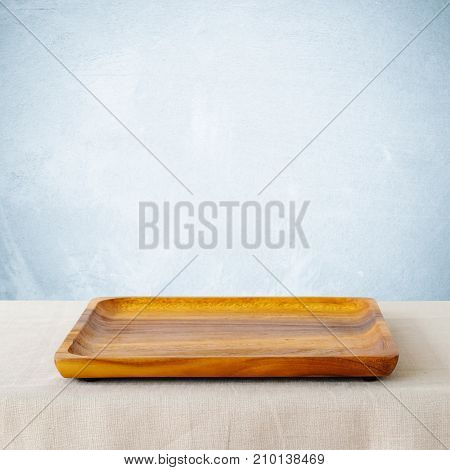 Empty squre wooden tray on sack tablecloth background banner food display montage food background