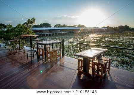 Lotus marsh and wood boat with sky background at Banglane Nakorn pathum Thailand.