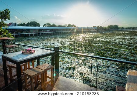 Lotus marsh and wood boat with sky background at Banglane Nakorn pathum Thailand.
