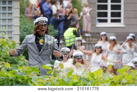 Stockholm Sweden - Jun 13 2017: Happy Teenagers Wearing Graduation Caps Running Out From School Afte