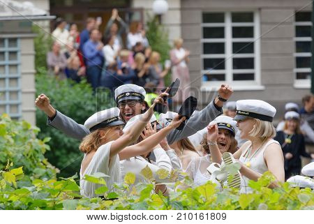 Stockholm Sweden - Jun 13 2017: Happy Teenagers Wearing Graduation Caps Dancing After Graduation At 