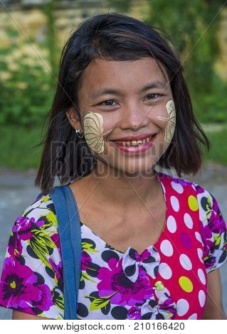 MANDALAY MYANMAR - SEP 03 : Portrait of Burmese girl with thanaka on face on Mandalay Myanmar on September 03 2017. Thanaka is paste made from ground bark