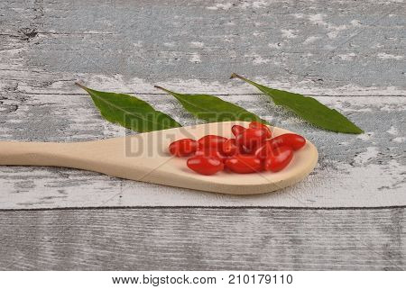 Gojiberry On Wooden Spoon And Timber