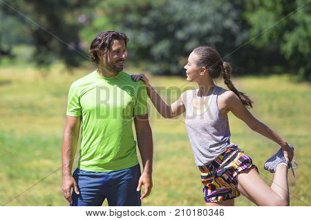 Smiling Couple Stretching Outdoors
