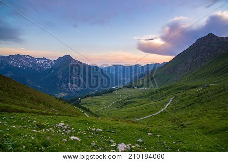 Mountain Road Leading To High Mountain Pass On The Italian Alps.. Expasive View At Sunset, Colorful