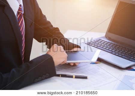 Businessman with cash dollars - business concepttablet and financeinvestmentsavesuccess and profitable business concepts.