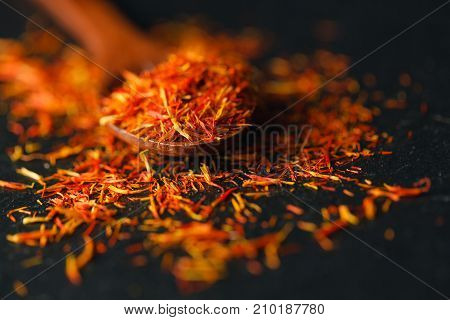 Dried Saffron Spice On Black Background. Raw Organic Pistil Powder Saffron Are Scattered On The Tabl